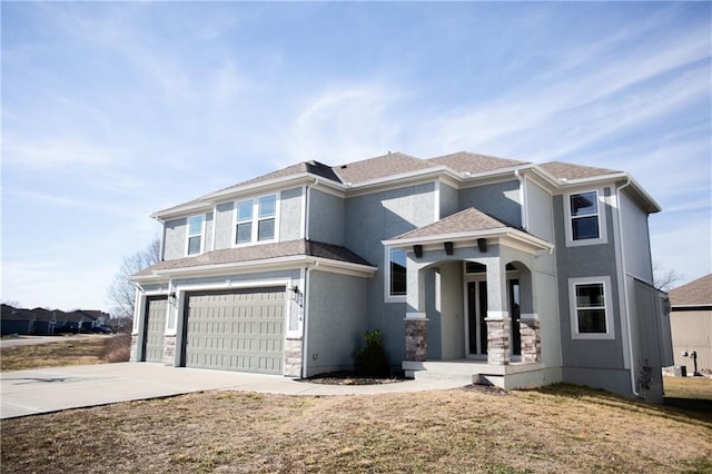 view of front of property with a garage and a front lawn