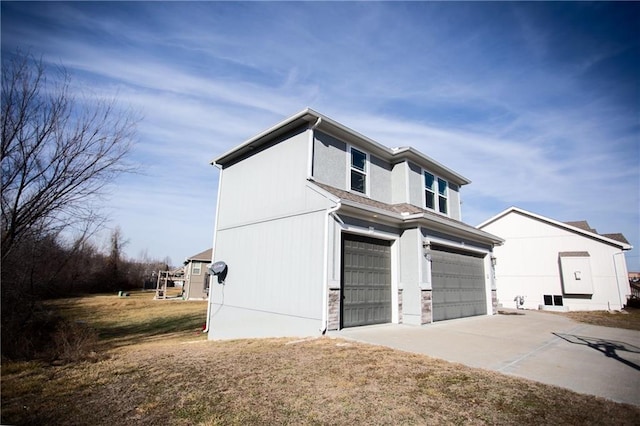 view of side of property with a garage and a lawn