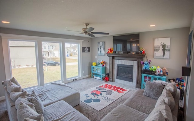 living room featuring ceiling fan, carpet, and a fireplace