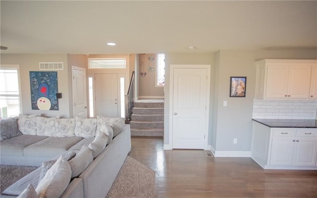 living room with dark hardwood / wood-style flooring