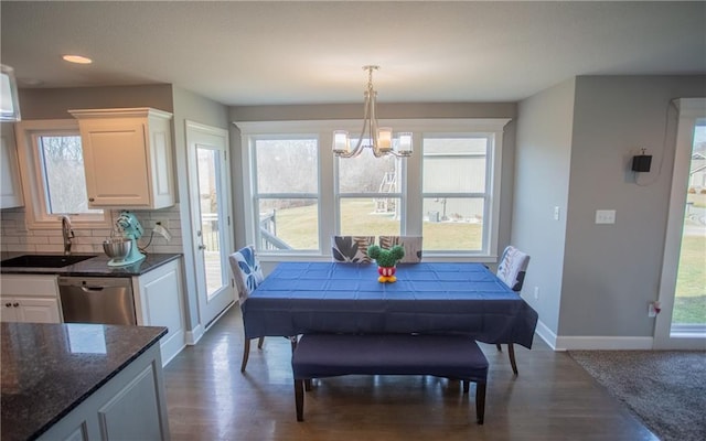 dining room featuring hardwood / wood-style flooring, a chandelier, and sink