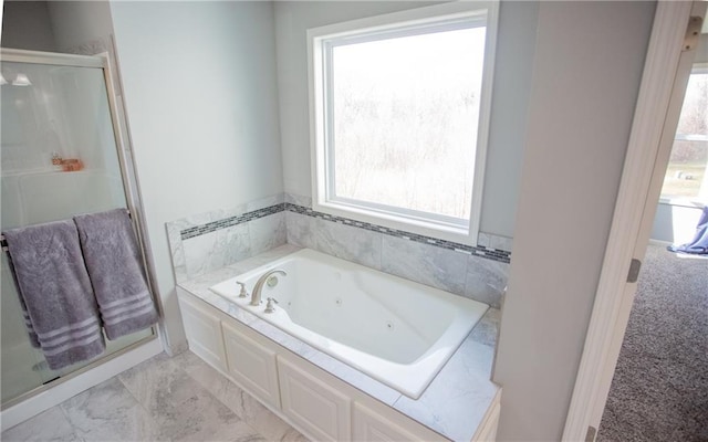 bathroom featuring independent shower and bath