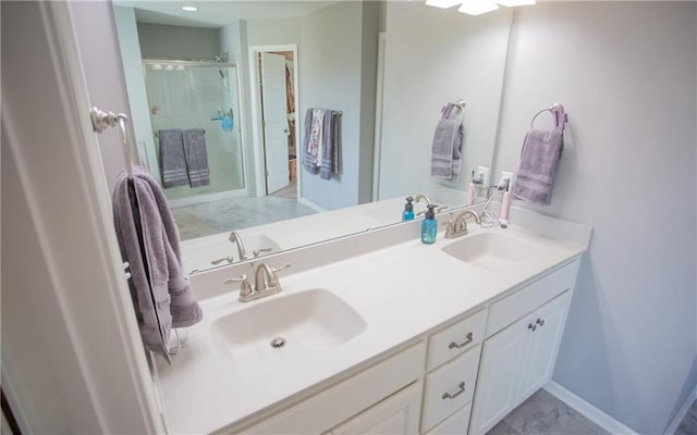 bathroom with vanity and a shower with shower door