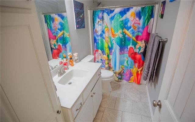 bathroom with vanity, curtained shower, tile patterned floors, and toilet