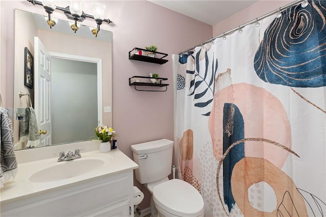 bathroom with toilet, curtained shower, and vanity