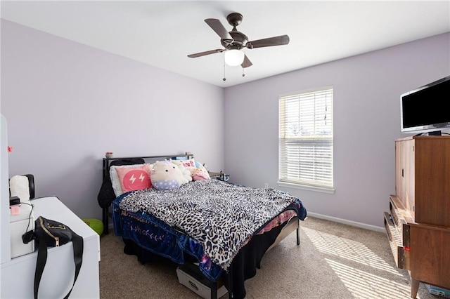 bedroom with a ceiling fan, carpet, and baseboards