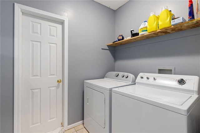 clothes washing area with laundry area, light tile patterned floors, baseboards, and independent washer and dryer