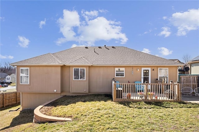 back of house with a patio area, a lawn, a fenced backyard, and roof with shingles