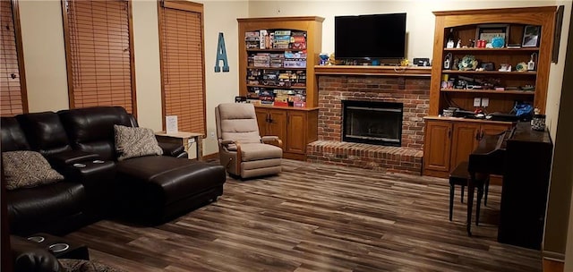 living room featuring a brick fireplace and dark wood-type flooring