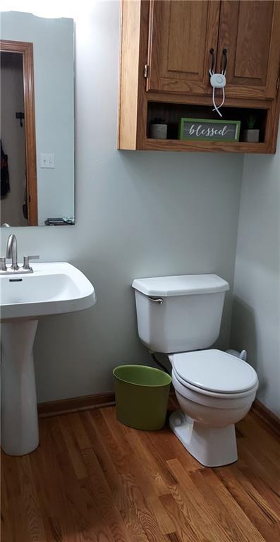 bathroom with sink, hardwood / wood-style flooring, and toilet