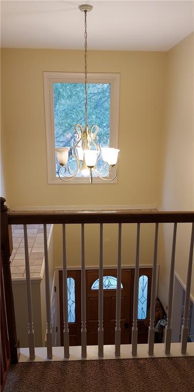 interior details featuring carpet floors and a chandelier