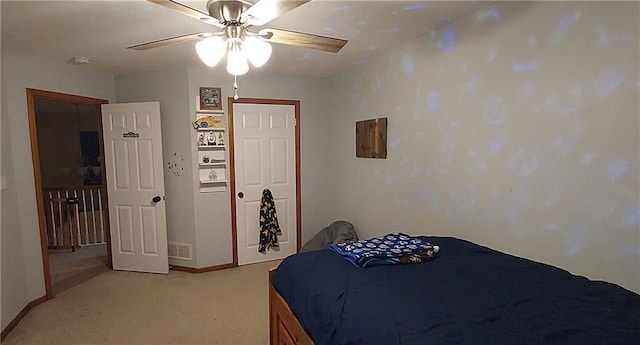 bedroom featuring ceiling fan and light carpet