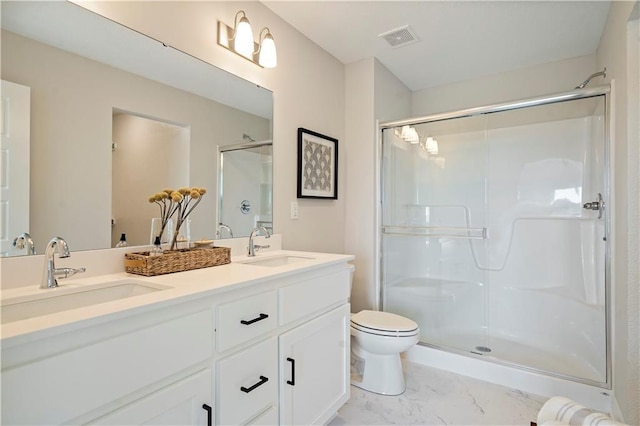 bathroom featuring vanity, toilet, and walk in shower