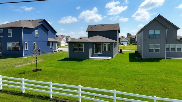 back of house with a lawn