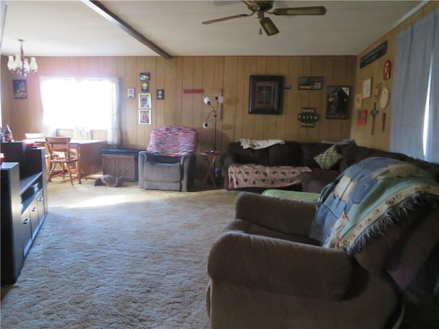 living room featuring carpet flooring and ceiling fan with notable chandelier