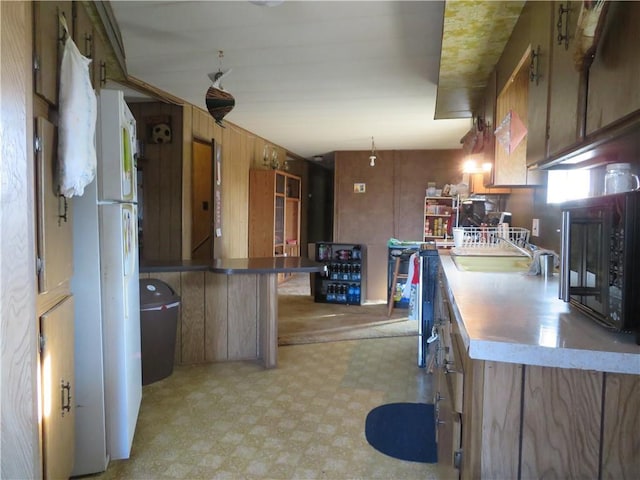 kitchen with white fridge and a breakfast bar area