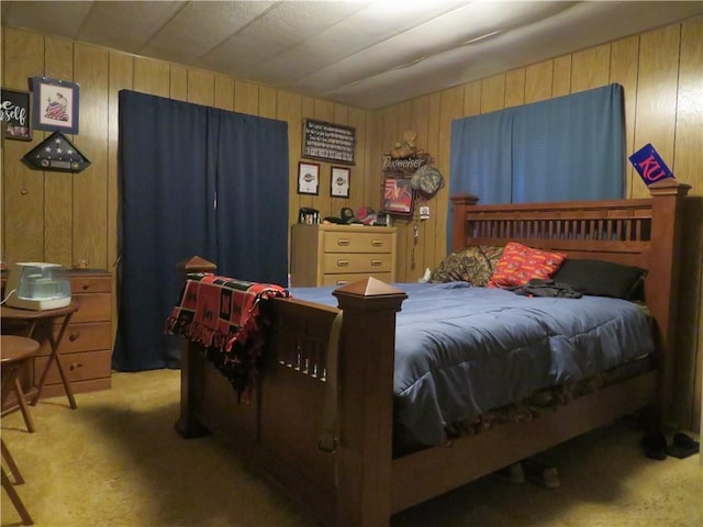 bedroom featuring carpet flooring and wood walls