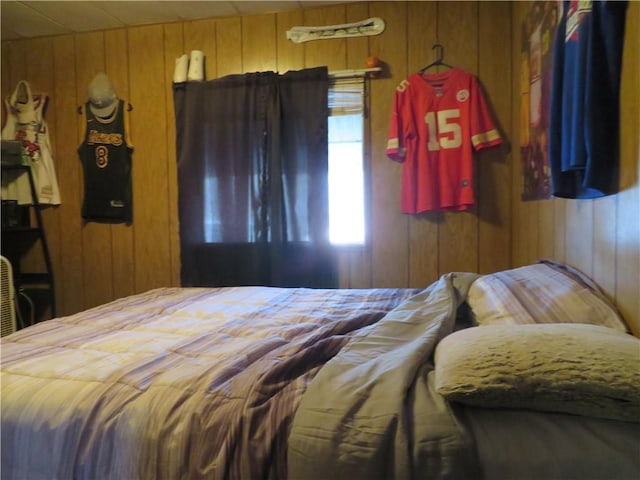 bedroom with wood walls