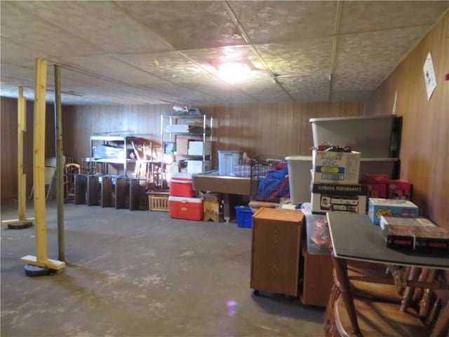 basement featuring wooden walls