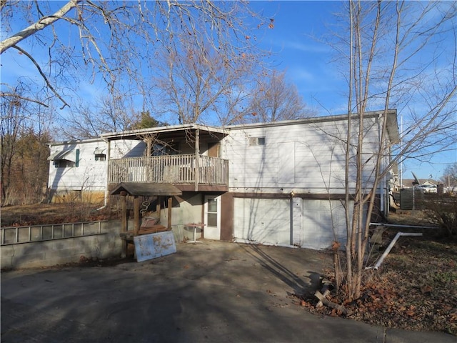 exterior space featuring a wooden deck and a garage