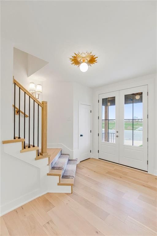 doorway with french doors and light wood-type flooring