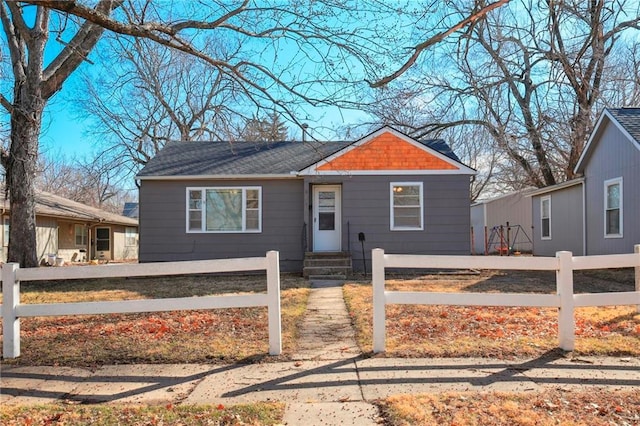 bungalow-style home with a fenced front yard