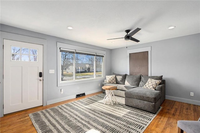 living room with hardwood / wood-style flooring, plenty of natural light, and ceiling fan