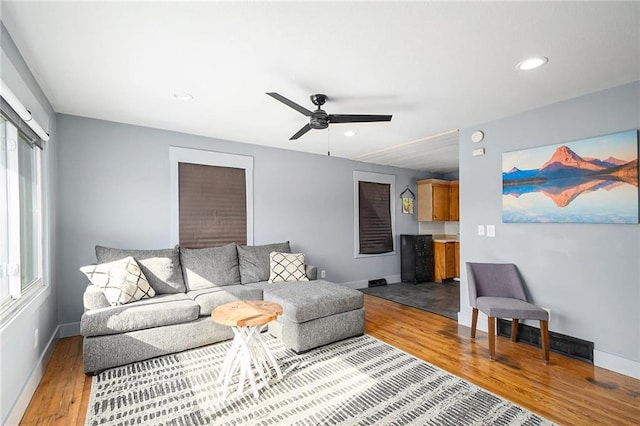 living room with hardwood / wood-style floors and ceiling fan