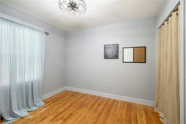 unfurnished room featuring hardwood / wood-style flooring and a healthy amount of sunlight