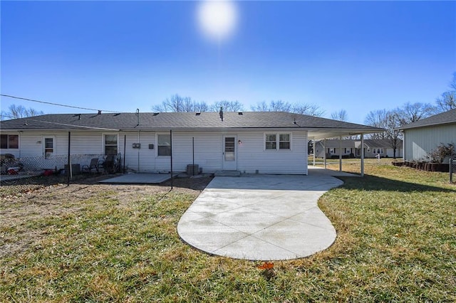 back of house with a patio and a yard