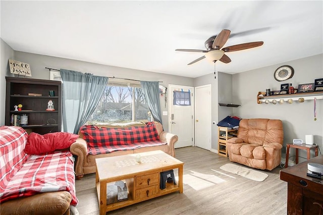 living room with ceiling fan and light wood-type flooring