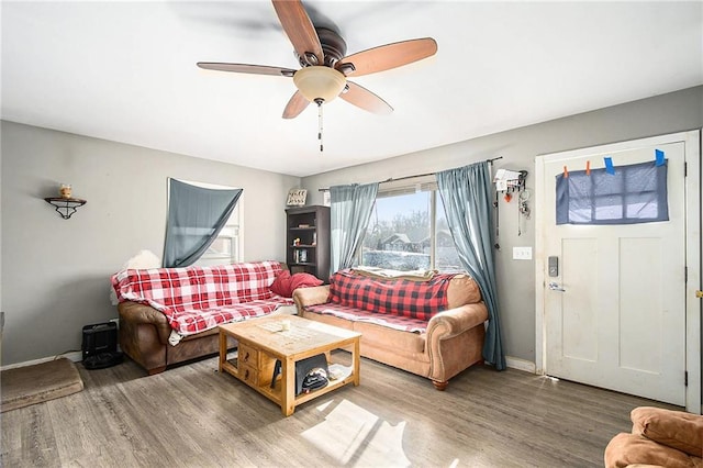 living room featuring ceiling fan and hardwood / wood-style floors