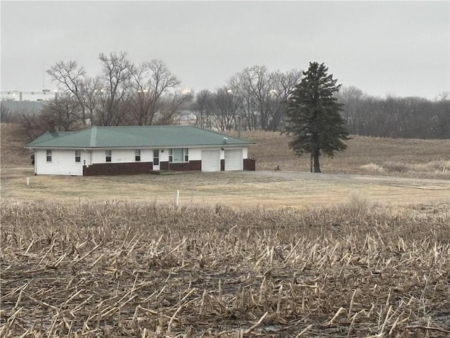 exterior space with a rural view and a garage