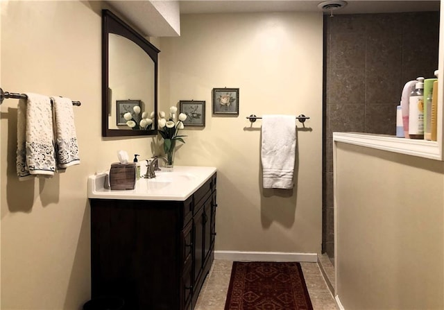 bathroom featuring walk in shower, vanity, and tile patterned flooring