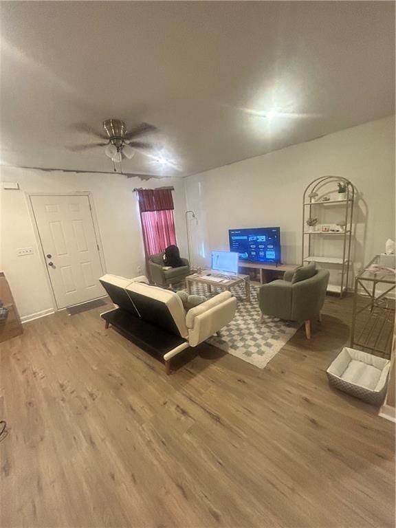 living room featuring hardwood / wood-style flooring and ceiling fan