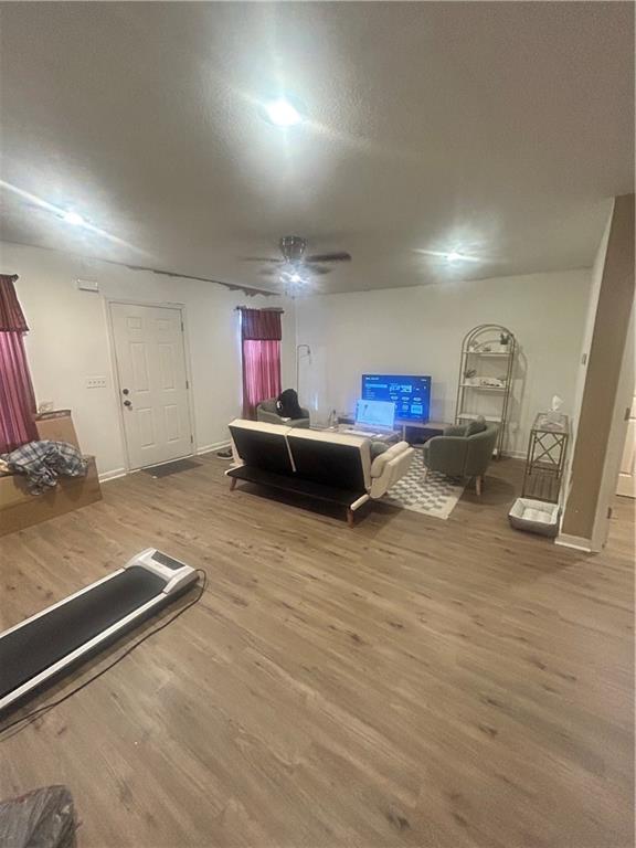 bedroom with hardwood / wood-style floors and ceiling fan