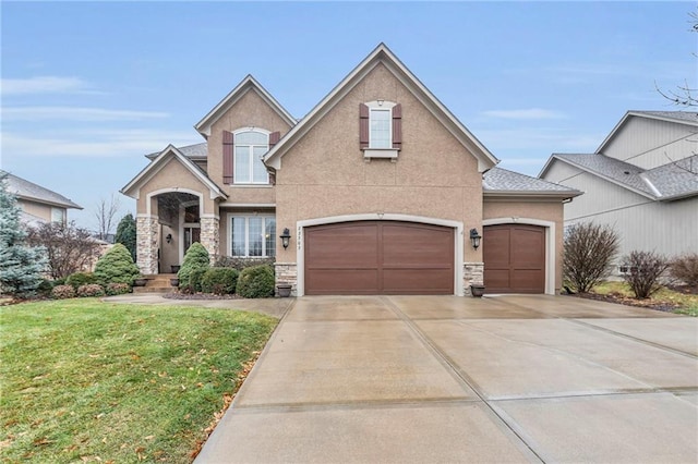 view of front of property with a garage and a front yard