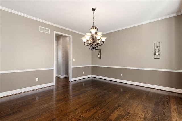 empty room with visible vents, crown molding, baseboards, a chandelier, and wood finished floors