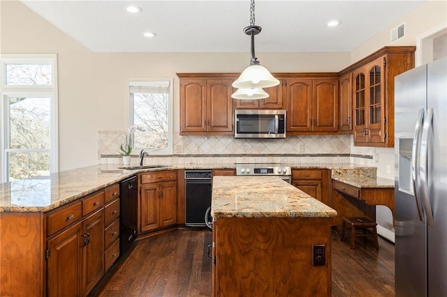 kitchen featuring a sink, stainless steel appliances, light stone countertops, and dark wood finished floors