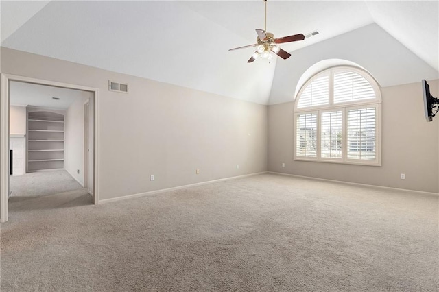 carpeted empty room featuring high vaulted ceiling, a ceiling fan, visible vents, and baseboards