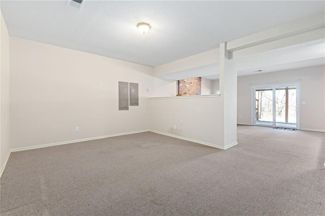 carpeted spare room with electric panel, visible vents, baseboards, and a textured ceiling