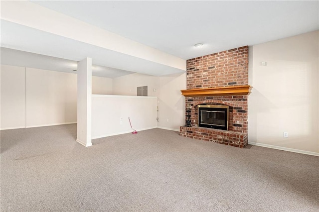 unfurnished living room featuring carpet flooring, a brick fireplace, baseboards, and visible vents