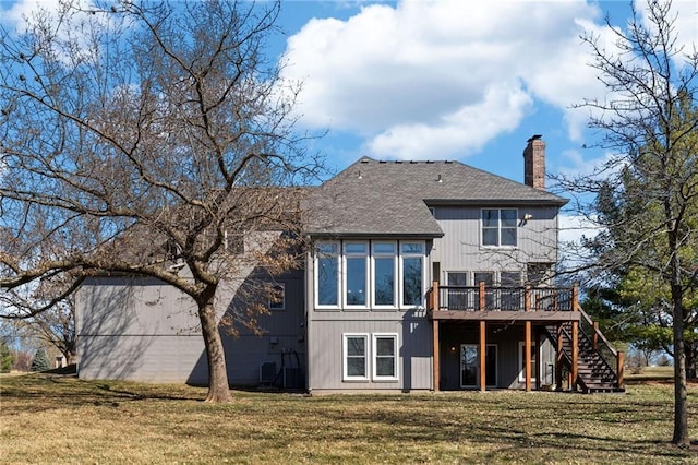 back of property featuring a chimney, stairway, a wooden deck, and a yard