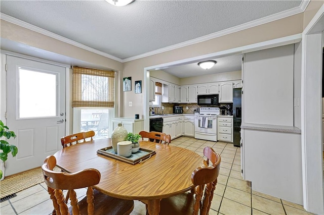 tiled dining area featuring crown molding, sink, and a textured ceiling