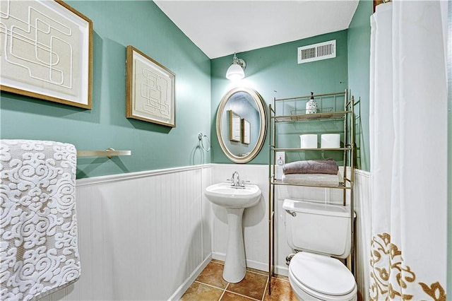 bathroom featuring tile patterned floors and toilet