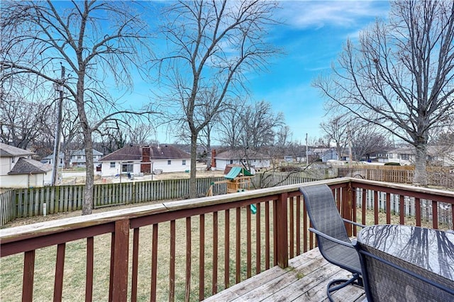 deck with a lawn and a playground