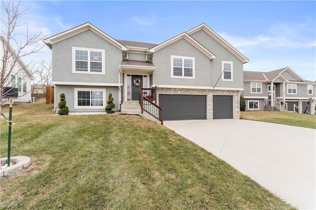 raised ranch with a garage and a front yard