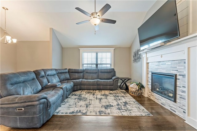 living room featuring dark wood-type flooring, vaulted ceiling, and ceiling fan with notable chandelier