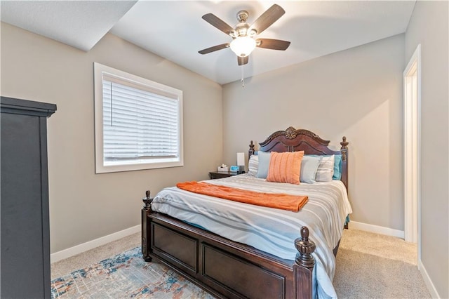 bedroom featuring light colored carpet and ceiling fan