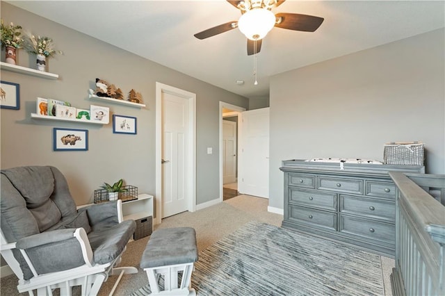 sitting room with ceiling fan and light carpet